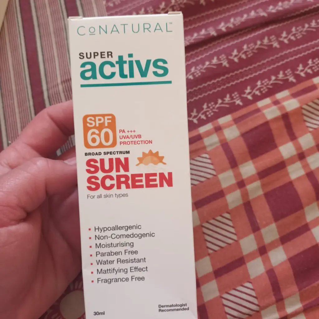 conatural sunscreen in hand
