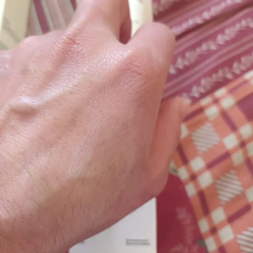 conatural sunscreen applied to the back of the hand showing its white cast