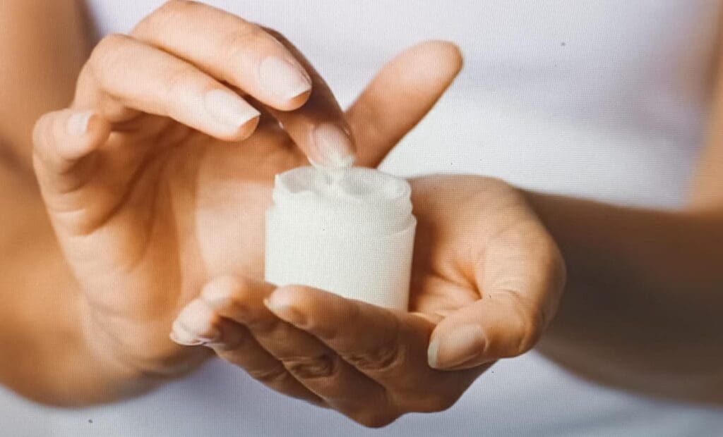 woman holding a moisturizer jar