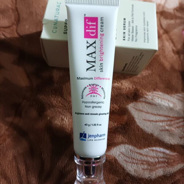 maxdif brightening cream tube front placed on bed